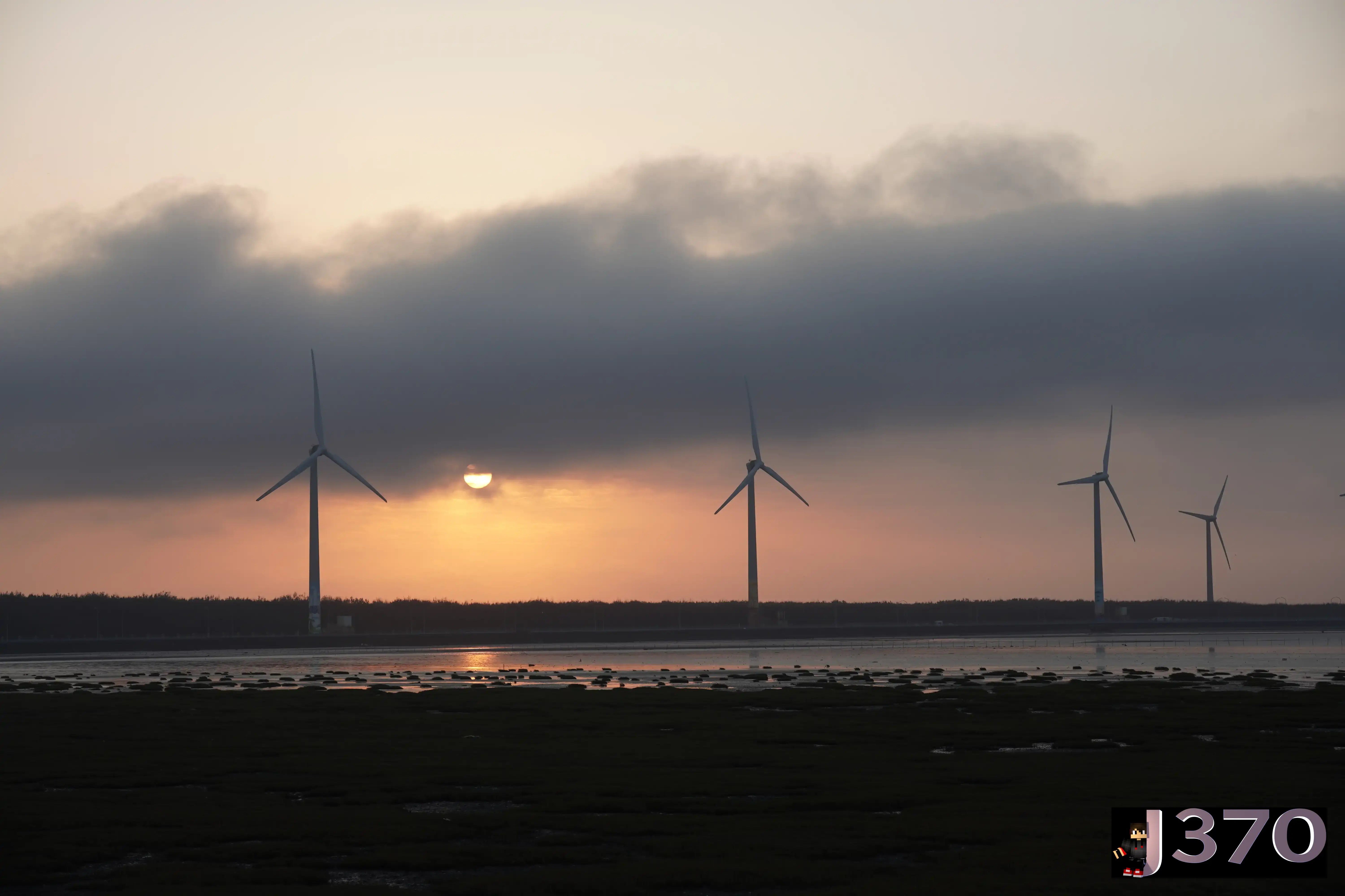 Crimson sunset with wind turbines