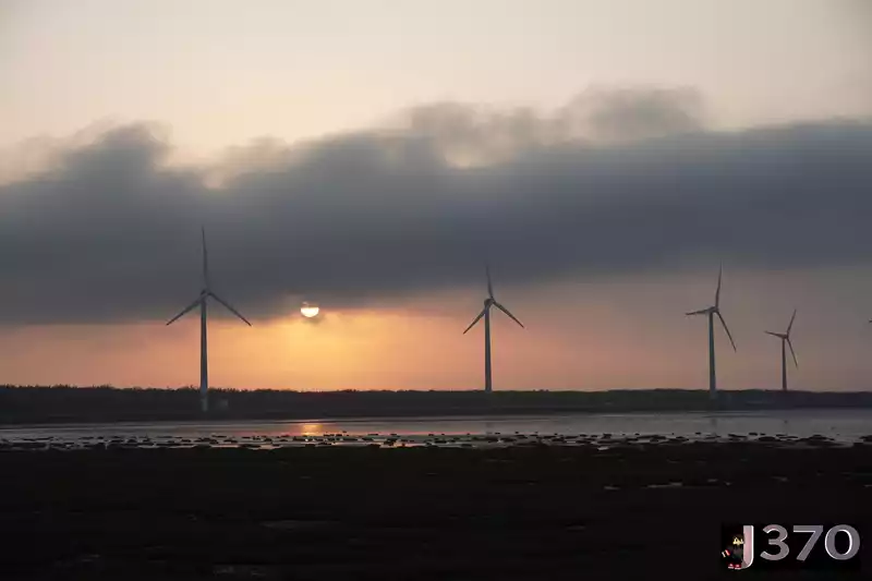 Crimson sunset with wind turbines